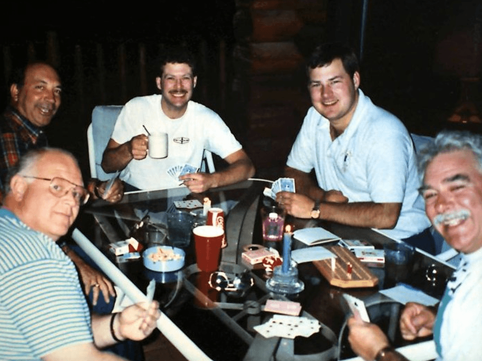 A white van driving on a streetA group of people sitting at a table