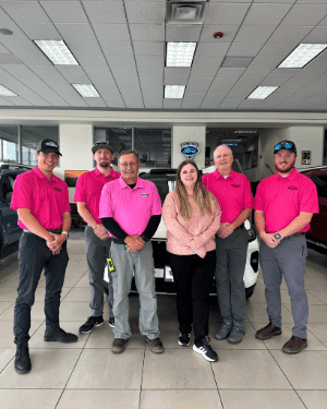 A group of people in pink shirts