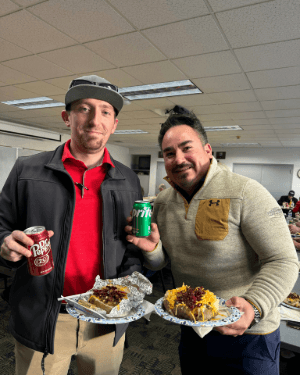 Two people holding plates of food