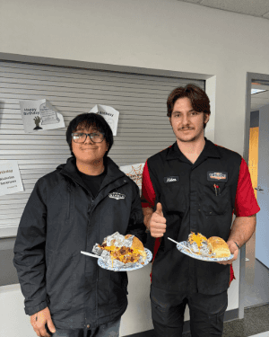 Two people holding plates of food
