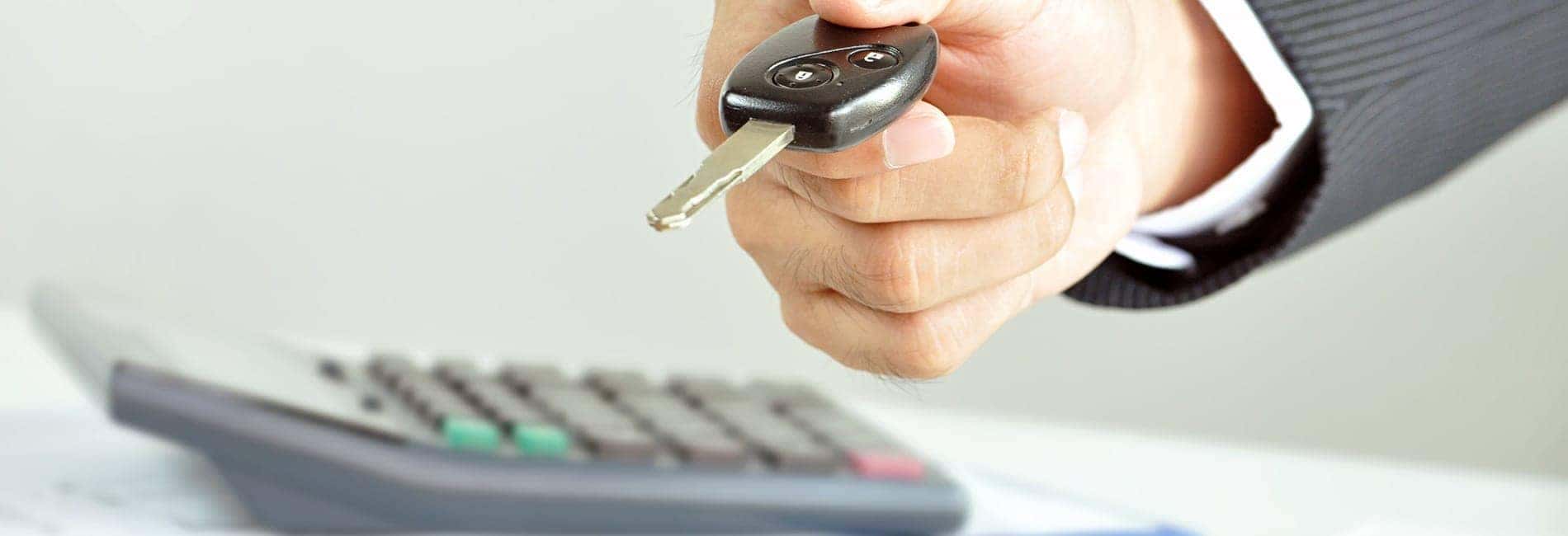 hand giving vehicle key