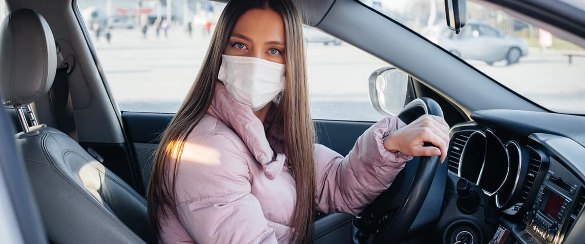 masked woman drives car