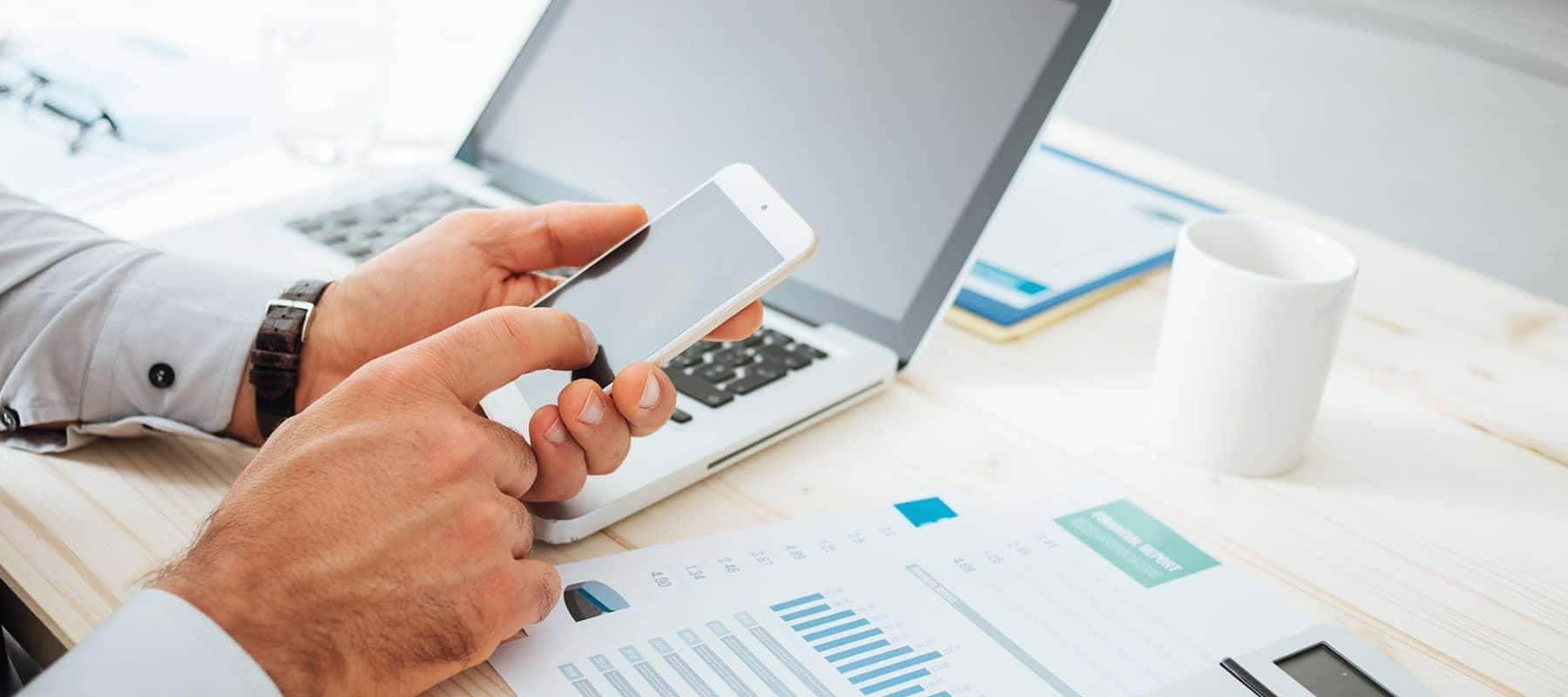 Hand typing on a mobile phone