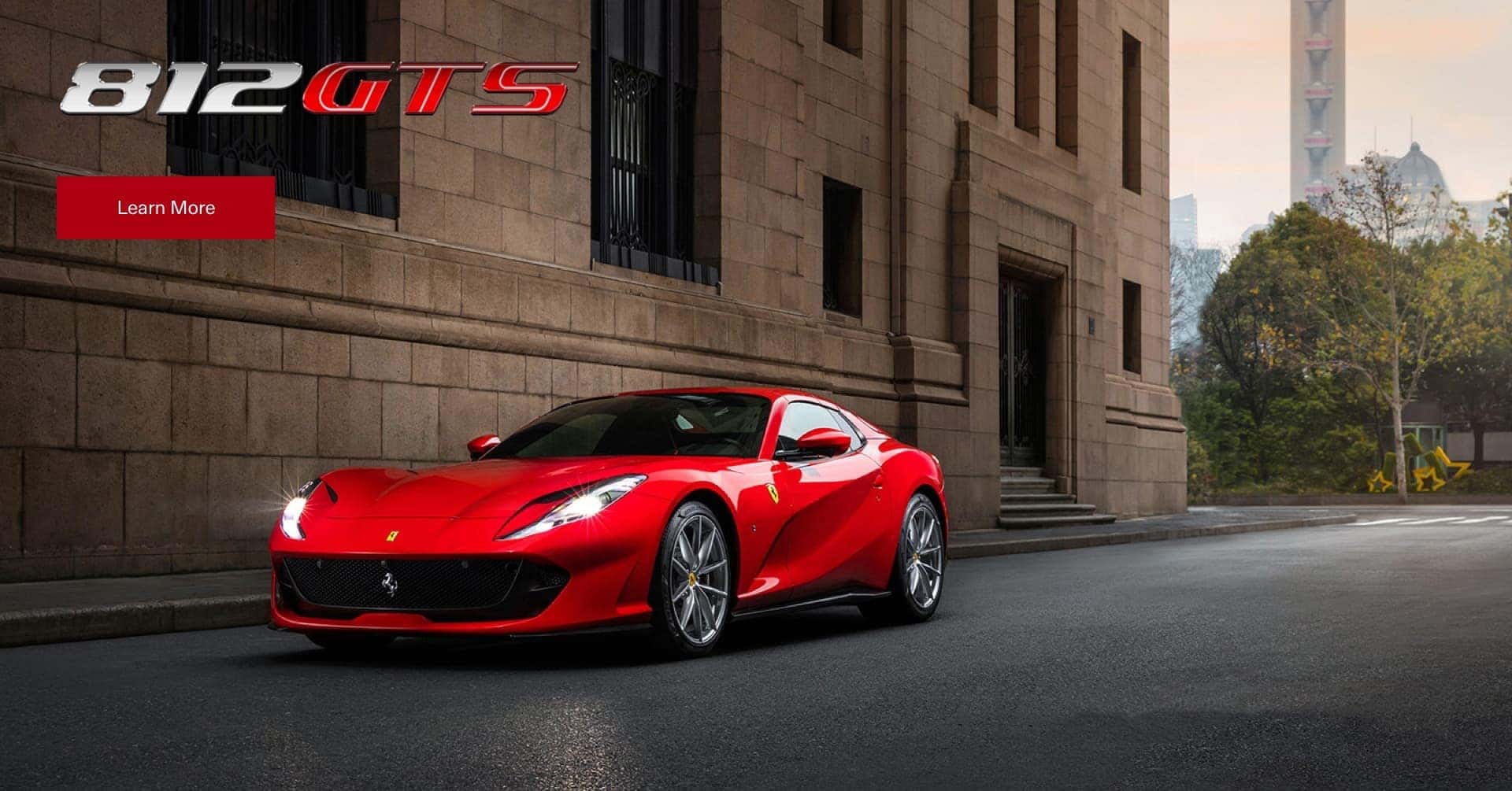 Red Ferrari 812 GTS next to a building