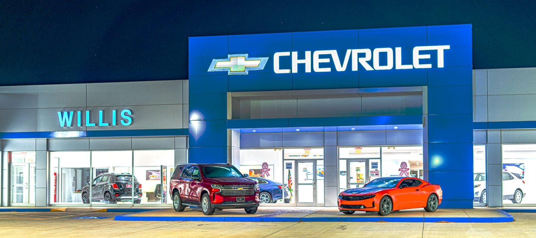 Front view of the dealership at night