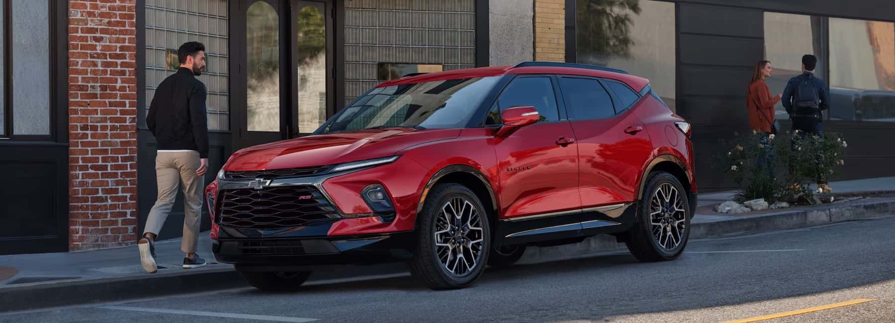man-walks-by-parked-2026-Chevy-Blazer