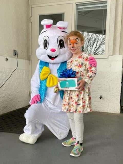 Girl-has-face-painted-and-posing-with-Easter-bunny