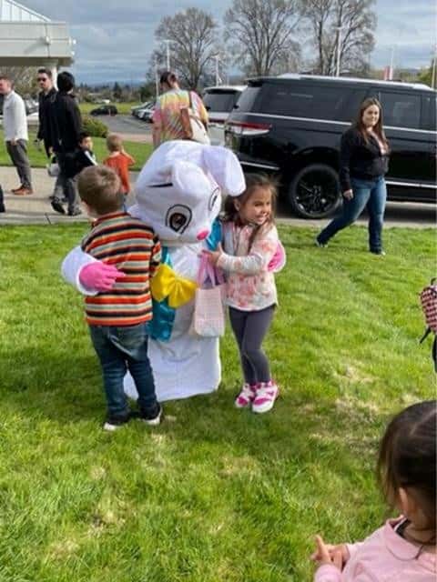 Two-children-hugging-the-Easter-Bunny