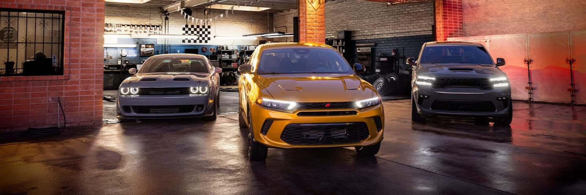 2024-Dodge-Hornet-parked-in-front-of-auto-repair-garage