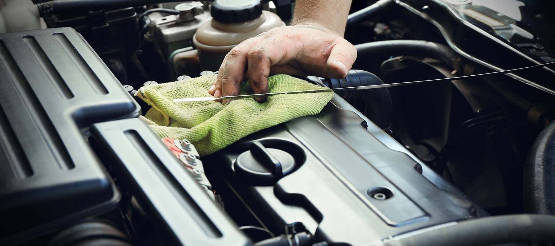 Oil-picture-of-technician-wiping-off-oil-dipstick