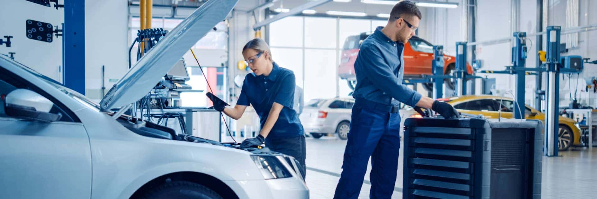 two-service-specialists-doing-maintenance-on-vehicle