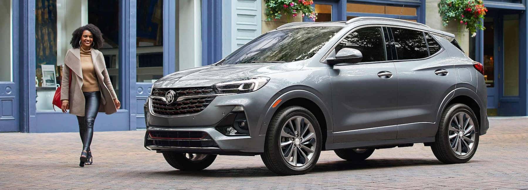 Woman walking next to 2023 Encore GX