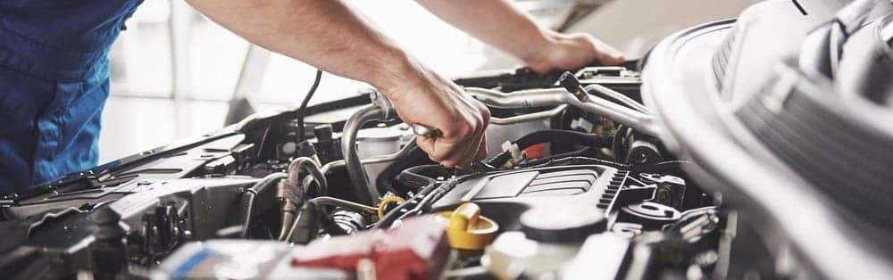 Mechanic Looking Under Hood of Car