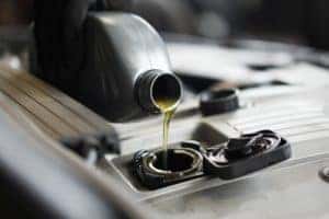 Oil Being Poured Into Car Engine