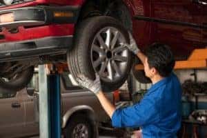 Tire on Vehicle Held By Tech