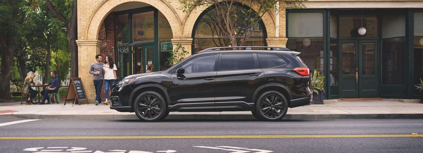 2022 Subaru Ascent parked in front of a trendy brick building