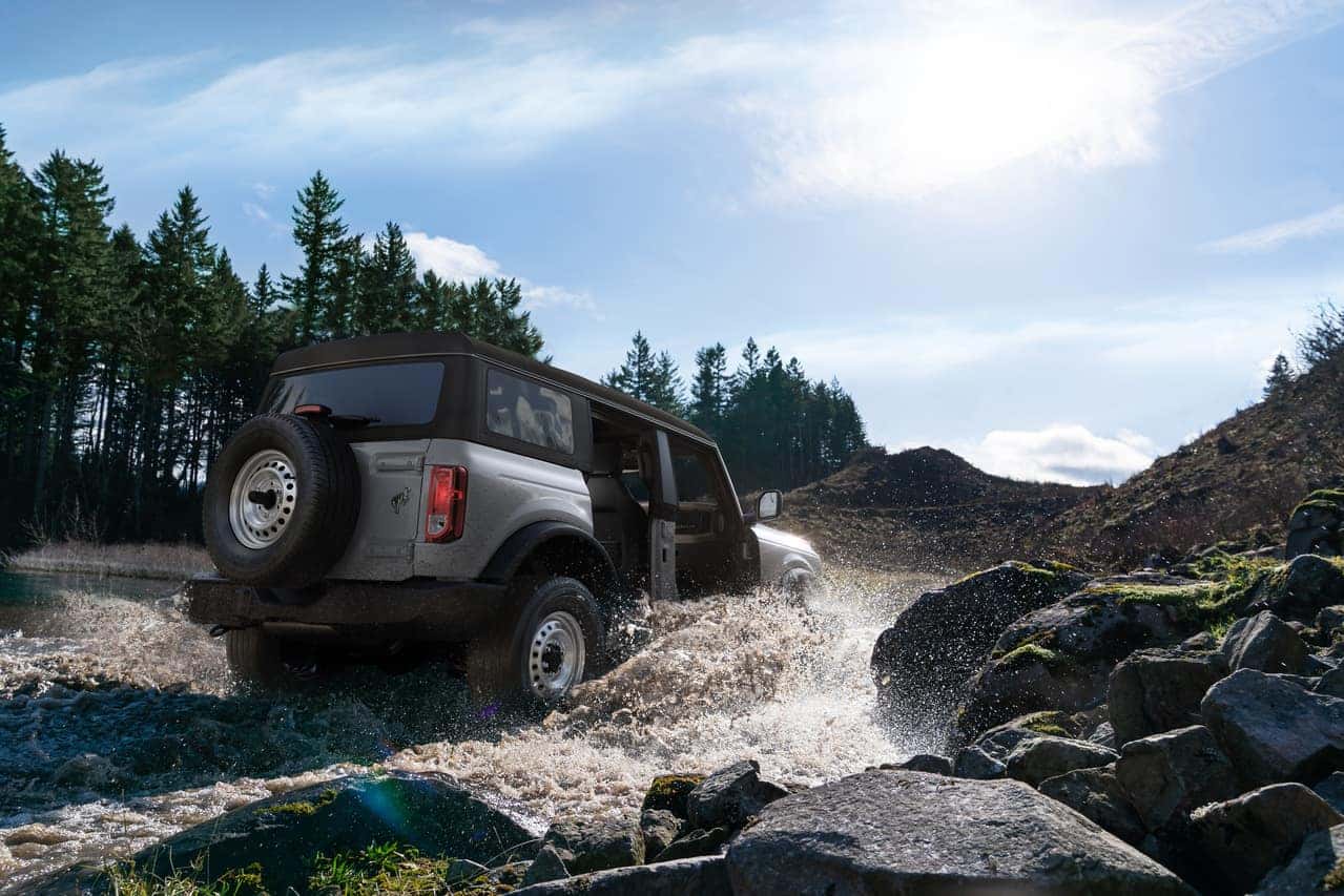 Bronco driving through river